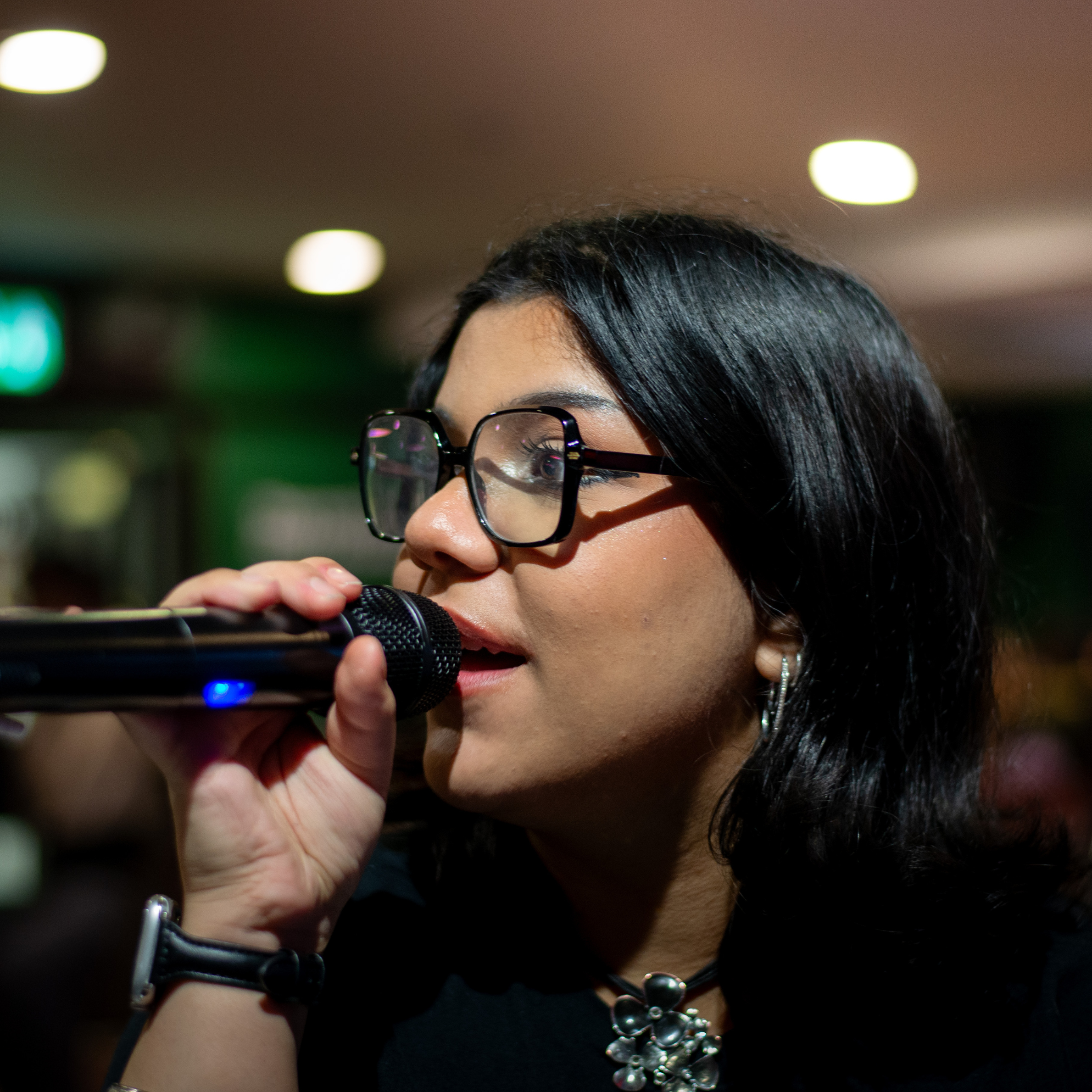 Image of person holding a microphone.