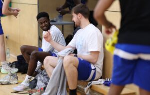 Basketball players chatting on the bench