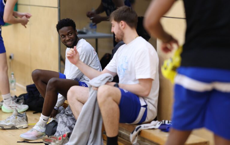 Basketball players chatting on the bench