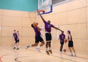 Student going up for a dunk during a basketball game
