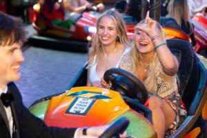 Students laughing on the dodgems at Leeds Ball