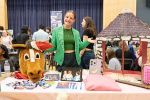 Student welcoming people to a society stall